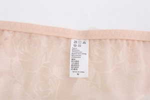 Detail view of the rose embroidery mesh fabric and material composition care label