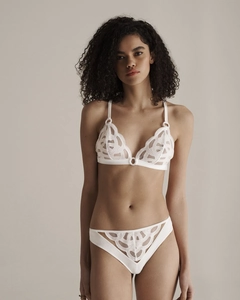 Detail of white lace embroidery lingerie set with delicate circular connector and sheer mesh