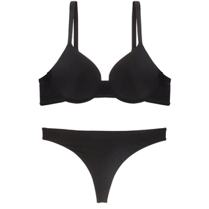 Detail of seamless black lingerie set featuring padded push-up bra and thong
