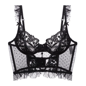 Close-up of black floral lace bustier top with sheer mesh and ruffle shoulder strap details