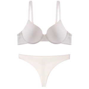 Detailed flat lay of a seamless white bra set with smooth cups and matching thong underwear
