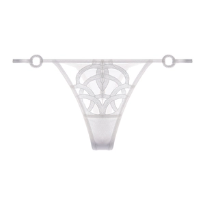 Detail of white lace thong featuring geometric embroidery and metal ring accents