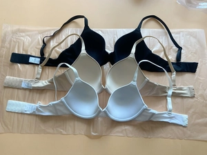 Three-pack seamless push-up bras in black, beige, and white colors with smooth finish