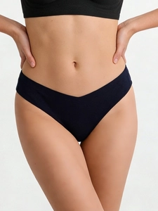Close-up of seamless V-shaped low waist thong in dark blue silky fabric on model