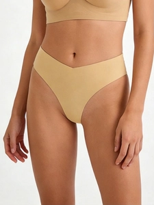 Detail of nude seamless high-cut thong showing laser-cut edges and elastic fit