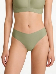 Seamless V-shaped thong in bean green fabric on a model for a smooth, high-elastic fit