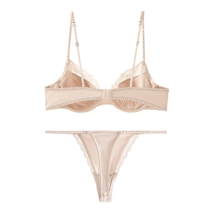 Close-up of pink satin lingerie set with delicate lace trim and underwired bra