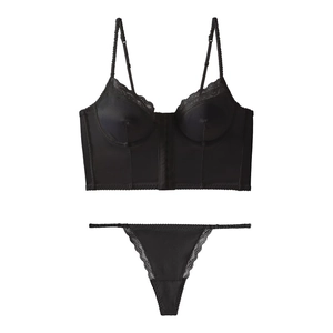 Detailed view of bohemian satin and lace lingerie set with front-closure corset and thong