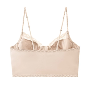 Detailed view of satin corset bra with lace trim and fine stitching in beige