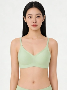 Detail of light green seamless bralette with thin straps and a soft V-neck design