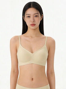 Front view of seamless beige bralette with adjustable straps and matching panties