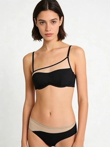 Detail of black tube bra with mesh panel and matching low-rise mesh panties on a model