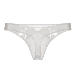 Detailed close-up of white floral lace thong with delicate embroidery and mesh fabric