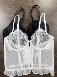 Detail of French lace corset with floral embroidery and fishbone support structure