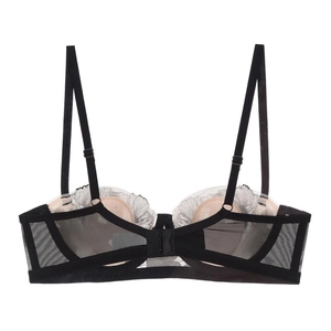 Detail view of black mesh bra with white lace trim, adjustable straps and back closure