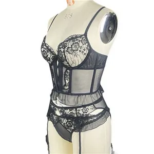 Detail of black lace corset lingerie featuring floral patterns and ruffle waist trim