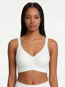 Detail of white seamless wireless bra featuring wide straps and a minimalist V-neck design