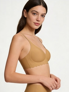 Detail view of seamless wireless bra with scalloped edges and adjustable thin straps