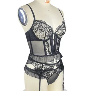Detail of black lace embroidery corset with adjustable garter straps and mesh ruffles