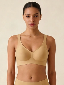 Front view of seamless skin-tone wireless bra with wide straps on a fashion model