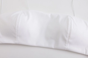 Close-up of white seamless bralette featuring thin straps and parallel reinforced stitching