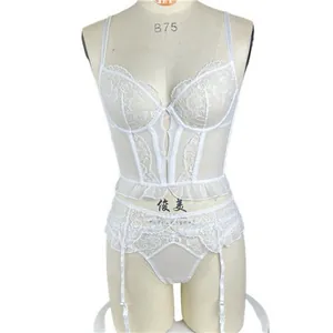 Detail of white lace lingerie set with corset top, embroidery, and garter straps