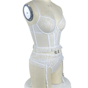 Side view of white floral lace corset with sheer mesh details and garter straps