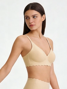 Detail of seamless beige bra with scalloped wave edges and comfortable thin straps