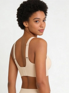 Close-up of seamless beige bra featuring wide straps and adjustable multi-row back buckle