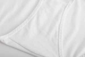 Close-up of fine mesh texture and double-needle stitching on white bandeau bra