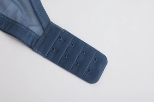 Close-up of dark blue lace bra with four-row back closure and breathable mesh fabric