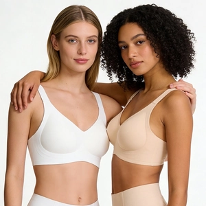 Detail view of seamless wide strap bras in white and beige with soft support stretch fabric