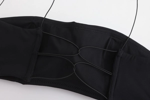 Detail of black seamless sports bra featuring multi-strap crisscross back design