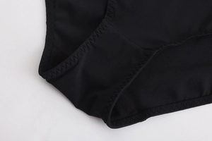 Detailed macro view of black seamless bra gusset featuring reinforced zig-zag stitching