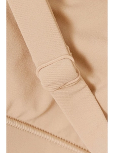 Close-up of nude triangle bra showing adjustable shoulder strap and ribbed fabric texture