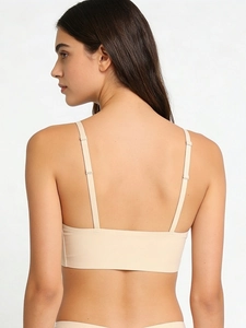 Detail of adjustable thin straps and seamless back design on beige bralette for women