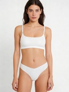 Macro detail of the seamless white thin bra with adjustable straps and matching thong set
