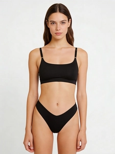 Front view of seamless black ultra-thin bra and matching high-cut panty set on model