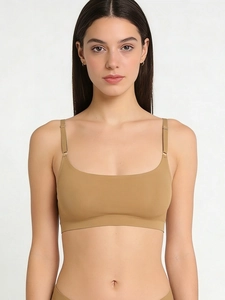 Detail showing seamless nude bralette with thin adjustable straps on professional model