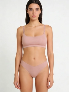 Detail view of pink seamless ultra-thin wireless bra and v-cut panty set on model