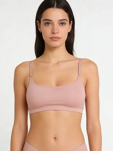 Detail of rose pink seamless lingerie set featuring adjustable straps and elastic knit fabric