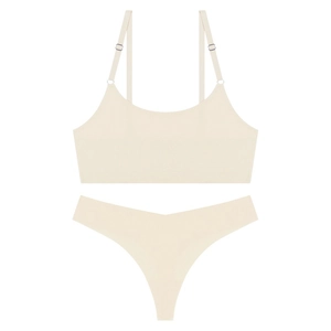Detail of seamless ultra-thin beige lingerie set with adjustable straps and thong