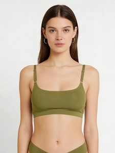 Detail view of olive green bralette with adjustable thin straps and metal buckles
