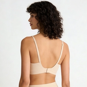 Rear view of seamless beige wireless bra set with adjustable straps and soft texture