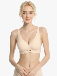 Detail of seamless beige deep V-neck bra with hollow-out design and soft support