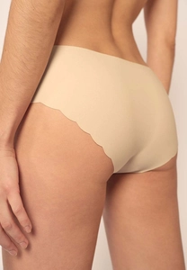 Detail of seamless skin-tone briefs with scalloped edges showing smooth fit on model