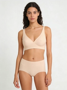 Close-up of seamless nude bra and high-waist panty set showing soft smooth fabric texture