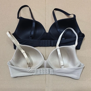 Close-up of triple row hook-and-eye closure and adjustable straps on wireless bras