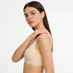 Side view of seamless nude bra with thin straps and smooth fabric on model