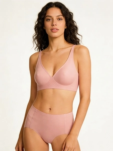 Detail of dusty pink seamless wireless bra and high-waist panties on a model
